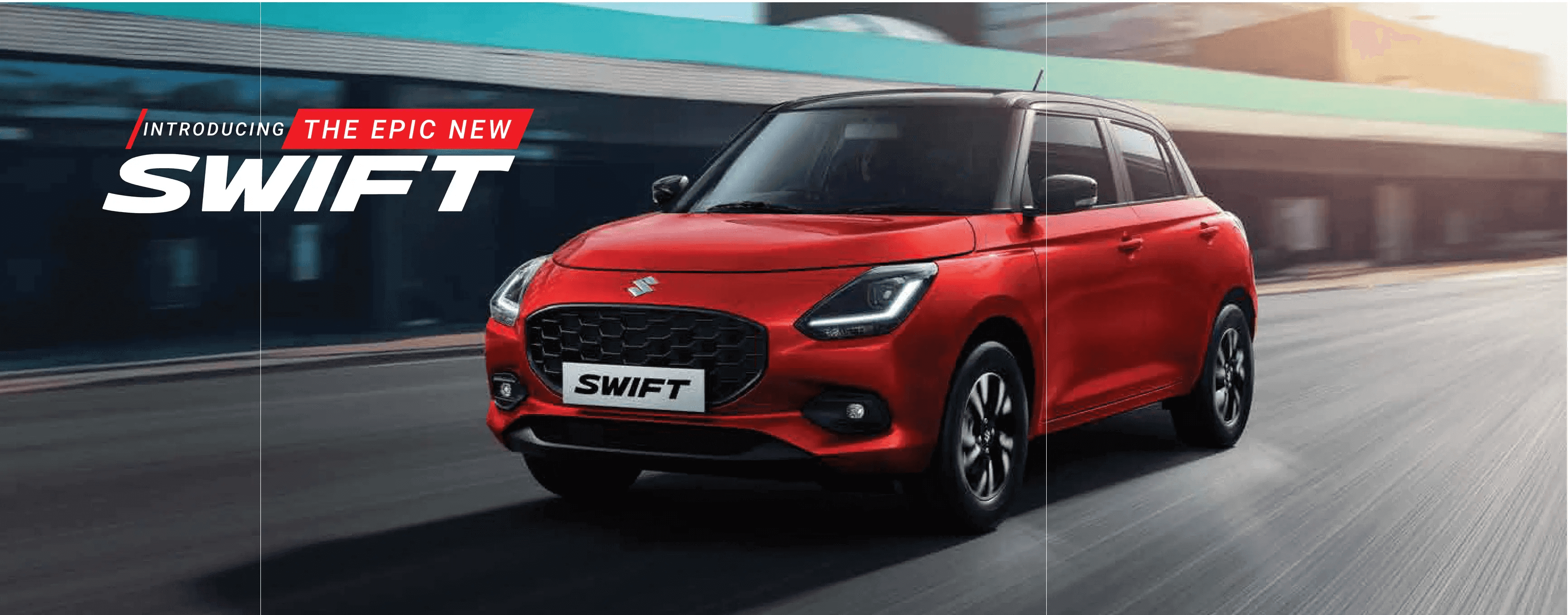 Image of a red Suzuki Swift car driving on a road. The background is blurred, indicating motion. The text on the image reads 'Introducing the Epic New Swift.'